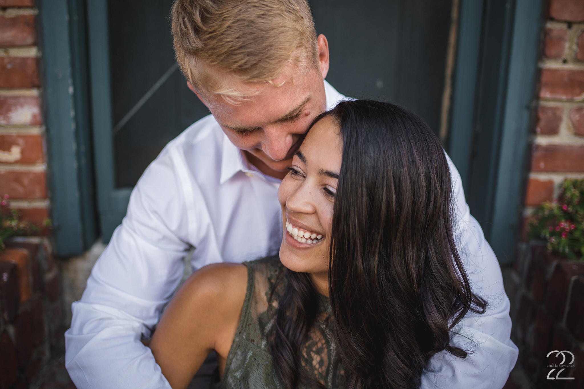 Up close photo of a man wrapping his arms around a woman from behind while sitting on the stairs, in Lebanon, Ohio by Dayton Wedding Photographer Studio 22 Photography